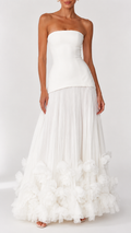 Front view of ivory strapless maxi dress with pleated skirt and floral hem